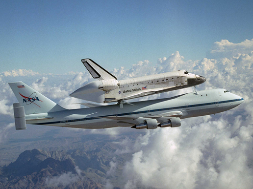 Space Shuttle Discovery stops atop NASA's modified Boeing 747 Shuttle Carrier Aircraft.
