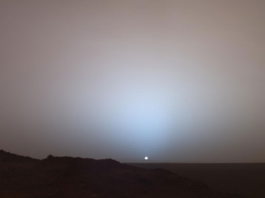 Sun sinks below the rim of the Gusev crater on Mars.