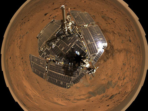 A self-portrait of the spacecraft deck and a panoramic mosaic of the Martian surface as viewed by NASA's Mars Exploration Rover Spirit.