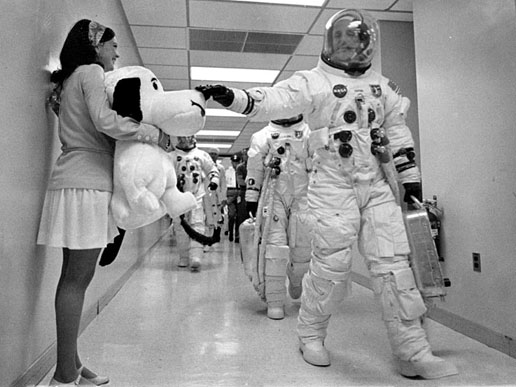 Apollo 10 commander Thomas P. Stafford pats the nose of Snoopy, the mission's mascot, held by Jamye Flowers, astronaut Gordon Coopers' secretary.