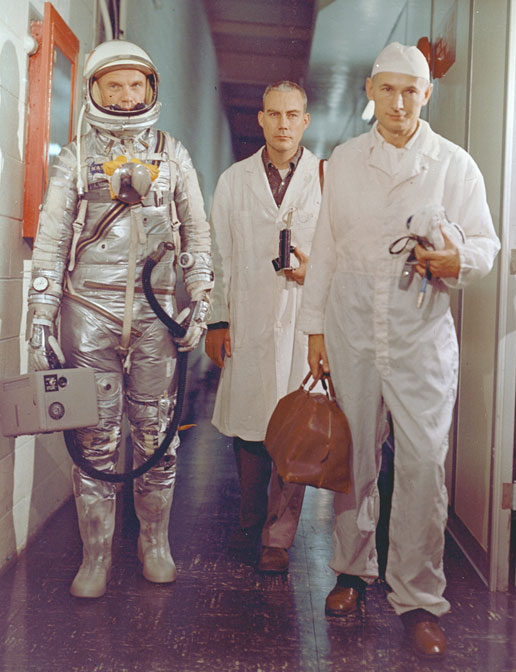 Astronaut John H. Glenn, Flight Surgeon Dr. William Douglas and equipment specialist Joe Schmitt