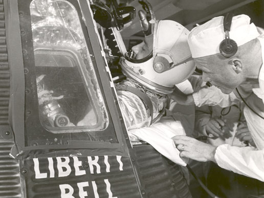 Astronaut Virgil I. Grissom climbs into the Liberty Bell 7 spacecraft the morning of July 21, 1961 with assistance from backup astronaut John Glenn.