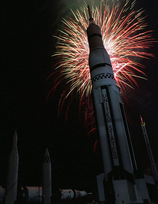 A replica of the original Saturn V rocket is silhouetted against the night sky during a celebration of the 30th anniversary of the lunar landing.