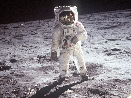 Astronaut Edwin E. Aldrin, Jr., lunar module pilot, walks on the surface of the Moon near the leg of the Lunar Module (LM)